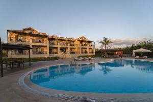 a large swimming pool in front of a hotel at Tsokas Hotel in Finikounta
