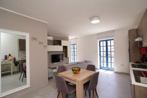 a kitchen and living room with a table and chairs at Mosta Dome Penthouse in Mosta