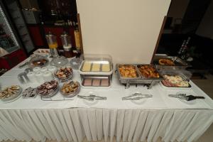 a table with many different types of food on it at Tsokas Hotel in Finikounta