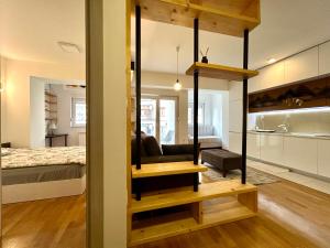 a loft bed in a room with a bedroom at Specialty Coffee Apartment in Skopje