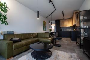 a living room with a couch and a table at Apartament Na Stoku Kielce in Kielce