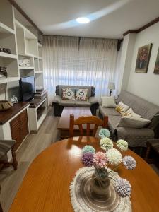 a living room with a couch and a table at Puerto de Bueu, Centro in Bueu
