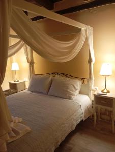 a bedroom with a canopy bed with white pillows at La Villa "Casa di Lydia" in Gavalochori