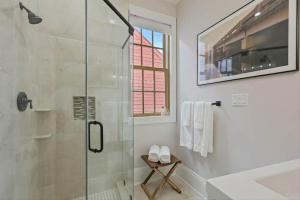 a bathroom with a shower with a glass door at Designer Home Walking Distance To The French Quarter's in New Orleans