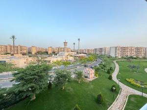 an aerial view of a city with buildings and a street at Luxury Inn: 3BR Amazing View in Madinaty B6 in Madinaty