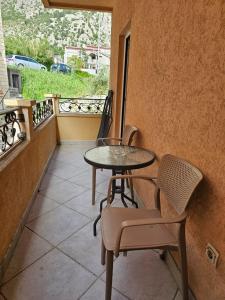 a patio with a table and chairs on a balcony at Apartments Carpe Diem in Kotor +29 photos