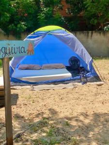 a blue tent on the beach with a mattress at Canoa Roots Hostel & Camping in Canoa Quebrada