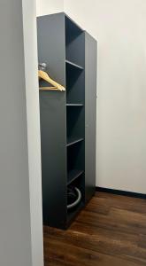 un placard noir avec des étagères dans une pièce dans l'établissement Apartments in Grani, à Dnipro