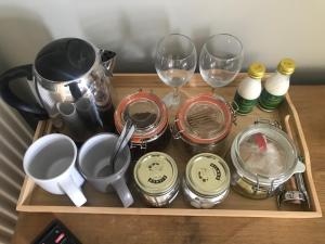 a tray with cups and wine glasses on a table at The Star in Narberth A Micro Pub with Rooms in Narberth