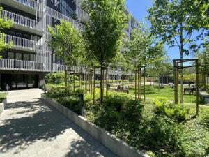 a park in front of a building with trees at Warsaw View Prestige Apartment in Warsaw
