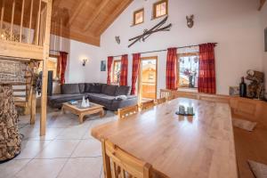 a living room with a table and a couch at Almhäuser Filzsteinalpe Almhaus 197 in Krimml