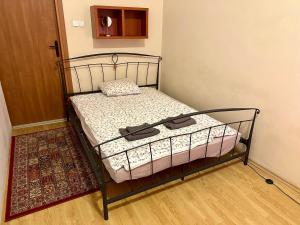 Wawel Apartament Centrum في كراكوف: سرير صغير في غرفة مع أرضية خشبية