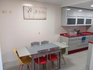 a kitchen with a table and four chairs at Turismo rural, San Sebastián,playa, parking privado in Azpeitia