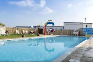 a large swimming pool with a water slide at Whitstable Vacation in Kent