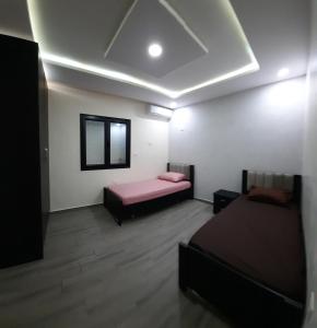 a room with two beds and a window at Villa mima in Midoun