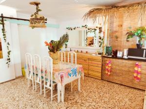 a dining room with a table and chairs and a mirror at Wonder Rooms Nerja Guest House in Nerja