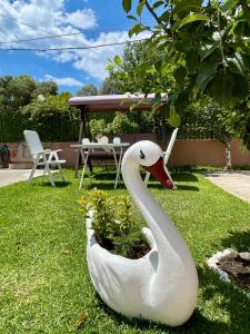 a statue of a swan sitting in the grass at Villa Almonds in Sozopoli