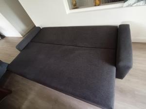 a couch sitting in a living room next to a wall at Tik69 in Craponne