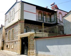 a brick building with a balcony on top of it at Domus Hotel in Korçë +28 photos