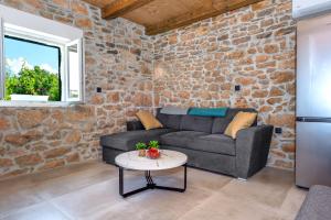 a living room with a couch and a table at Villa Lea&Robi in Unešić