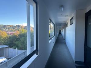 a hallway of a building with windows and a view at Ballina Motel in Napier