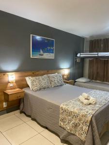 um quarto com uma cama com duas toalhas em Serra Negra Pousada Spa em Guarapari