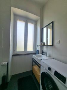 a bathroom with a sink and a washing machine at Apartment Eufemia in Kanfanar