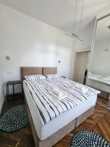 a large bed in a room with a mirror at Apartment Eufemia in Kanfanar