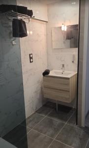 a bathroom with a sink and a shower at Au Complex By Suprême in Laboutarié