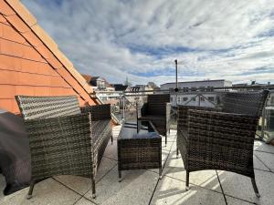 a patio with chairs and a table on a balcony at Kapitänshaus W16 E in Laboe