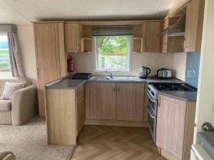 a small kitchen with a sink and a stove at Town View in Killarney