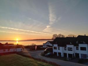 a sunset over a city with houses and a street at fewo1846 - Promenade Wassersleben in Harrislee