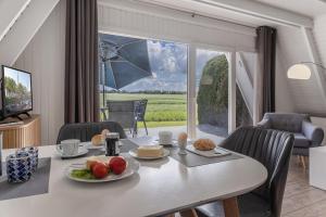 a dining room with a table with food on it at 50099Deichnest in Carolinensiel