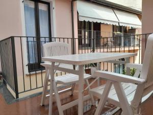 a wooden table and two chairs on a balcony at Apparthotel Oleggio in Oleggio