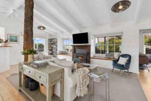 a living room with a couch and a fireplace at Oceanside haven opposite the surf beach in Ocean Grove