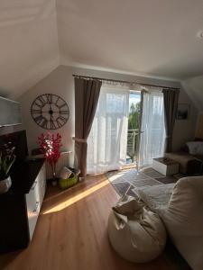 a bedroom with a bed and a large window at Apartament Róża in Giżycko