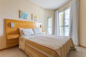 Ένα ή περισσότερα κρεβάτια σε δωμάτιο στο Apart hotel a Beira Mar na praia do Recreio +140 φωτογραφίες