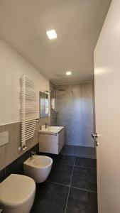 a bathroom with a white toilet and a sink at Casa Zagni in Piombino +18 photos