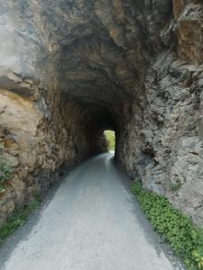 a tunnel in a rock wall on a road at El cortijo azul in Güéjar-Sierra +36 photos