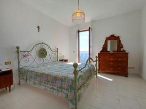a bedroom with a bed and a dresser and a mirror at Casa Atana - a Tuscan gem in Licciana Nardi