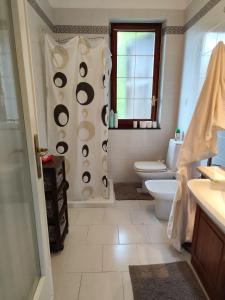 a bathroom with a shower with a toilet and a window at Casa Atana - a Tuscan gem in Licciana Nardi