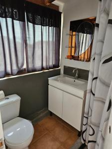 a bathroom with a toilet and a sink at Blue eagle Guesthouse in Santa Maria