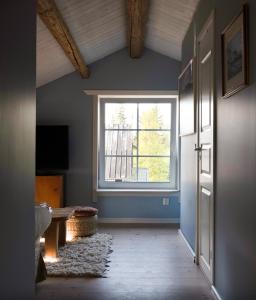 an empty room with a window and a door at Lovely cabin with a beautiful view over Byske river in Byske