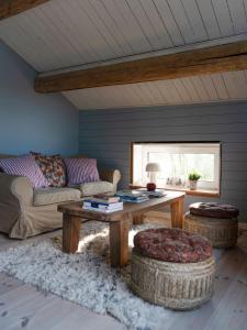 a living room with a couch and a coffee table at Lovely cabin with a beautiful view over Byske river in Byske