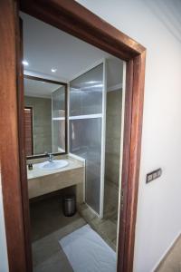 a bathroom with a sink and a mirror at Hotel Buenavista Dakhla in Dakhla