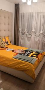 a bedroom with a bed with a football jersey on it at Apartament de lux white&red in Suceava