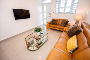 sala de estar con sofá y mesa en Spacious Retreat with Private Jacuzzi and Terrace, en Ponce