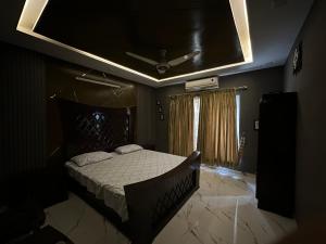 a bedroom with a bed and a ceiling fan at Villa Islamabad Central Hill View Park View in Islamabad