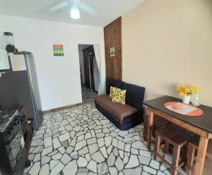 a living room with a couch and a table at Kitinete Girassol 1 - Penha SC - Beto Carrero in Penha