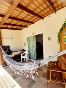 a hammock in the middle of a living room at Kitinete Girassol 1 - Penha SC - Beto Carrero in Penha